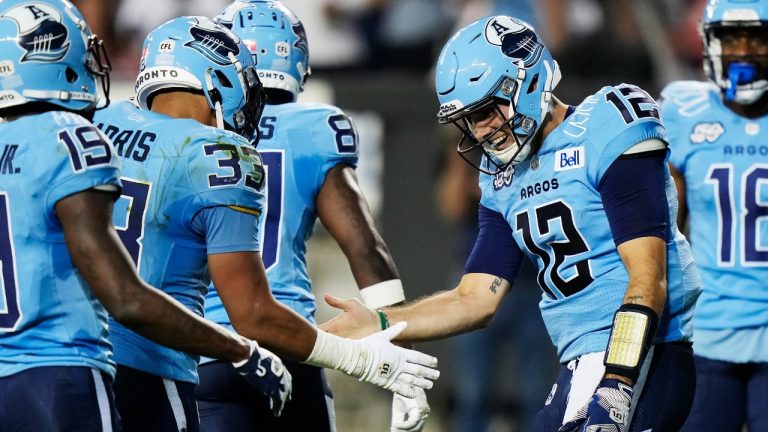 Toronto Argonauts quarterback Chad Kelly (12) celebrates his touchdown against the Calgary Stampeders with teammates during first half CFL football action in Toronto on Friday, August 25, 2023. (Frank Gunn/CP)