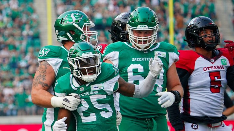 Saskatchewan Roughriders running back Jamal Morrow (25) celebrates with teammates after scoring a touchdown against Ottawa Redblacks during the first half of CFL football action in Regina on Sunday, August 6, 2023. (Heywood Yu/THE CANADIAN PRESS)
