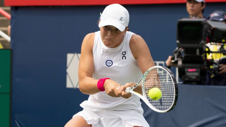 Iga Swiatek of Poland hits a return to Karolina Pliskova of Czech Republic during the National Bank Open tennis tournament in Montreal, Wednesday, Aug. 9, 2023. (Christinne Muschi/CP)