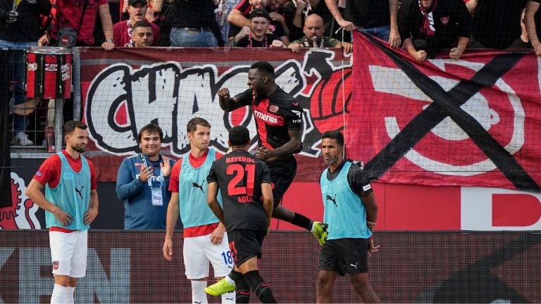 Leverkusen's Victor Boniface celebrates after he scores a penalty goal against Heidenheim's goalkeeper Kevin Mueller during the German Bundesliga soccer match between Bayer Leverkusen and FC Heidenheim in Leverkusen, Germany, Sunday, Sept. 24, 2023. (Martin Meissner/AP Photo)