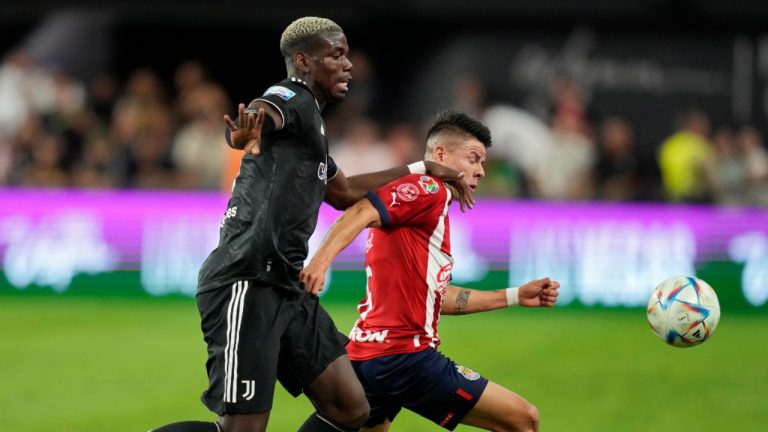Juventus' Paul Pogba, left, and Chivas' Pavel Perez battle for the ball during the first half of a friendly soccer match Friday, July 22, 2022, in Las Vegas. (John Locher/AP)