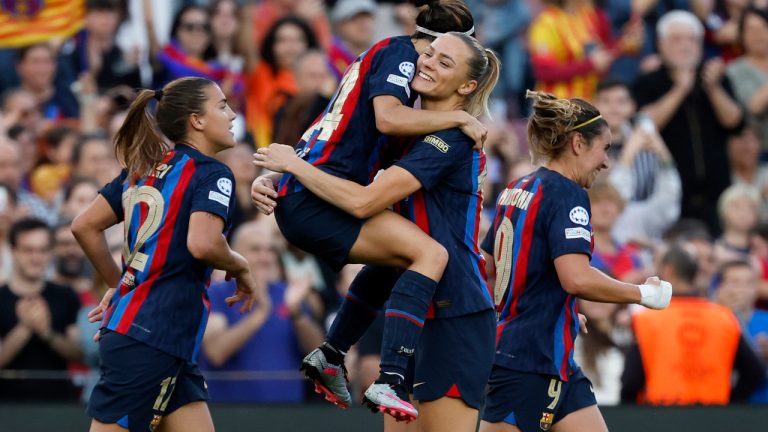Barcelona's Aitana Bonmati jumps into the arms of Fridolina Rolfo celebrating after teammate Caroline Graham Hansen scored the opening goal during the Women's Champions League semifinal, second leg, soccer match between FC Barcelona and Chelsea FC at the Camp Nou stadium in Barcelona, Spain, Thursday, April 27, 2023. (Joan Monfort/AP)