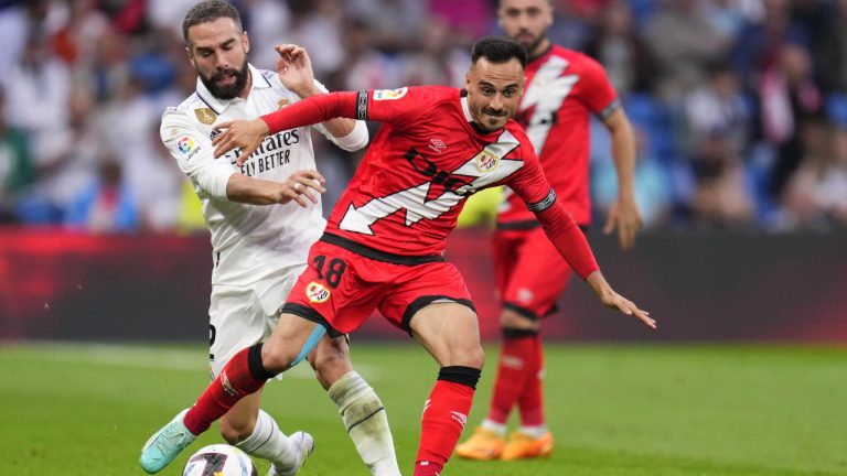 Real Madrid's Dani Carvajal, left, and Rayo's Alvaro Garcia challenge for the ball during a Spanish La Liga soccer match between Real Madrid and Rayo Vallecano at the Santiago Bernabeu stadium in Madrid, Spain, Wednesday, May 24, 2023. (Manu Fernandez/AP)