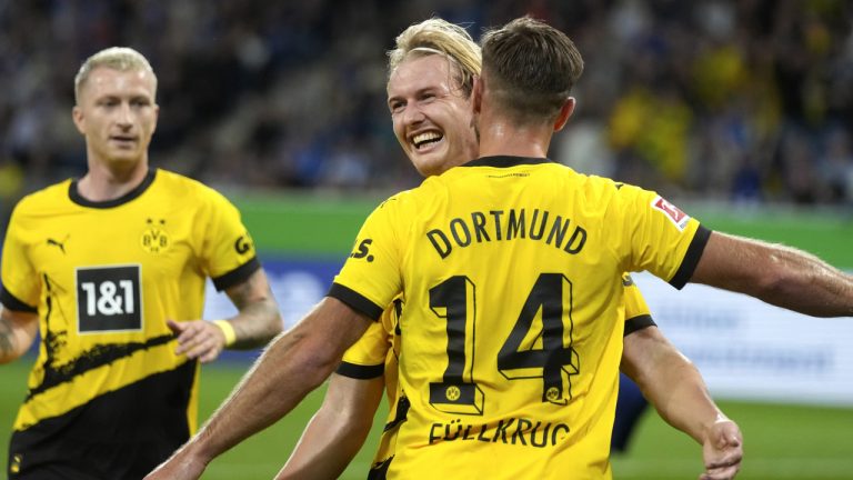 Dortmund players celebrate their side's opening goal during a German Bundesliga soccer match between TSG 1899 Hoffenheim and Borussia Dortmund in Sinsheim, Germany, Friday, Sept.29, 2023. (Michael Probst/AP)