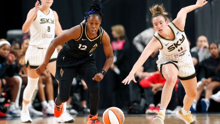 Las Vegas Aces guard Chelsea Gray (12) and Chicago Sky guard Marina Mabrey (4) chase the ball during the first half of Game 1 in a first-round WNBA basketball playoff series Wednesday, Sept. 13, 2023, in Las Vegas. Sky forward Alanna Smith is at left. (Steve Marcus/Las Vegas Sun via AP)