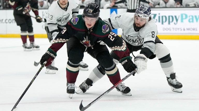 Los Angeles Kings defenseman Drew Doughty, right, tries to poke the puck away from Arizona Coyotes center Barrett Hayton during the first period of an NHL hockey game Saturday, Feb. 18, 2023, in Los Angeles. (Mark J. Terrill/AP)