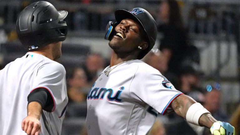 Miami Marlins' Jazz Chisholm Jr., right, celebrates with the bat boy as he returns to the dugout after hitting a solo home run off Pittsburgh Pirates starting pitcher Quinn Priester during the third inning of a baseball game in Pittsburgh, Saturday, Sept. 30, 2023. (Gene J. Puskar/AP)