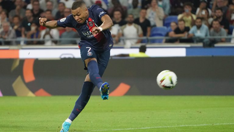 PSG's Kylian Mbappe shoots on target during the French League One soccer match between Lyon and Paris Saint-Germain at the Groupama stadium, outside Lyon, France, Sunday, Sept. 3, 2023. (Laurent Cipriani/AP)