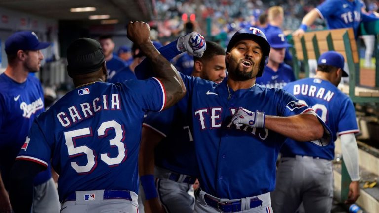Texas Rangers' Marcus Semien celebrates his home run against the Los Angeles Angels with Adolis Garcia during the ninth inning of a baseball game Wednesday, Sept. 27, 2023, in Anaheim, Calif. (Jae C. Hong/AP Photo)
