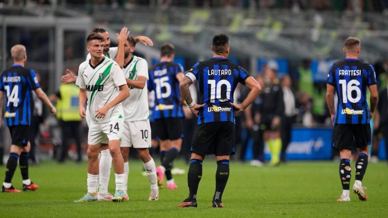 Sassuolo players celebrate as Inter Milan players are dejected after the Serie A soccer match between Inter Milan and Sassuolo at the San Siro Stadium, in Milan, Italy, Wednesday, Sept. 27, 2023. (Antonio Calanni/AP Photo)