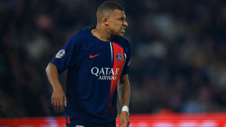 PSG's Kylian Mbappe grimaces after sustaining an injury during the French League One soccer match between Paris Saint Germain and Olympique de Marseille at Parc des Princes stadium in Paris, France, Sunday, Sept. 24, 2023. (Aurelien Morissard/AP)