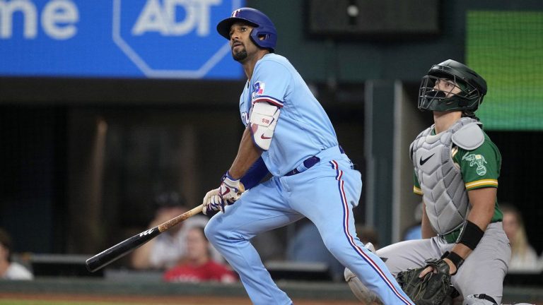 Texas Rangers' Marcus Semien and Oakland Athletics catcher Tyler Soderstrom watches Semien's double to left in the second inning of a baseball game. (Tony Gutierrez/AP)