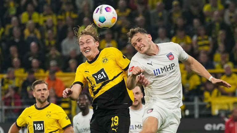 Heidenheim's Tim Siersleben, right, and Dortmund's Julian Brandt challenge for the ball during the German Bundesliga soccer match between Borussia Dortmund and FC Heidenheim in Dortmund, Germany, Friday, Sept. 1, 2023. (Martin Meissner/AP)