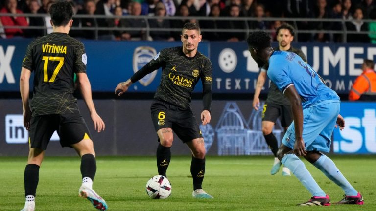 PSG's Marco Verratti, center, is challenged by Troyes' Lucien Agoume during the French League One soccer match between Troyes and Paris Saint Germain, at the Stade de l'Aube, in Troyes, France, Sunday, May 7, 2023. (Lewis Joly/AP)