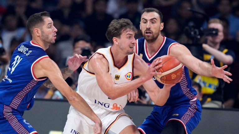 Serbia guard Stefan Jovic (24) and Serbia center Nikola Milutinov, right, put pressure on Germany guard Franz Wagner (9) during the championship game of the Basketball World Cup in Manila, Philippines, Sunday, Sept. 10, 2023. (Michael Conroy/AP)