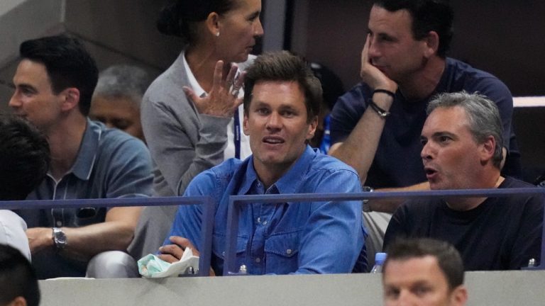 Former quarterback Tom Brady, center, attends a match between Carlos Alcaraz, of Spain, and Daniil Medvedev, of Russia, during the men's singles semifinals of the U.S. Open tennis championships. (John Minchillo/AP)
