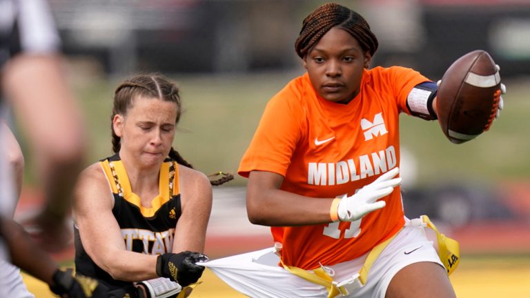 Ottawa defensive end Jennifer Anthony, left, tackles Midland's JaNasia Spand (11) during an NAIA flag football game in Ottawa, Kansas, Friday, March 26, 2021. The National Association of Intercollegiate Athletics introduced women's flag football as an emerging sport this spring. (Orlin Wagner/AP)