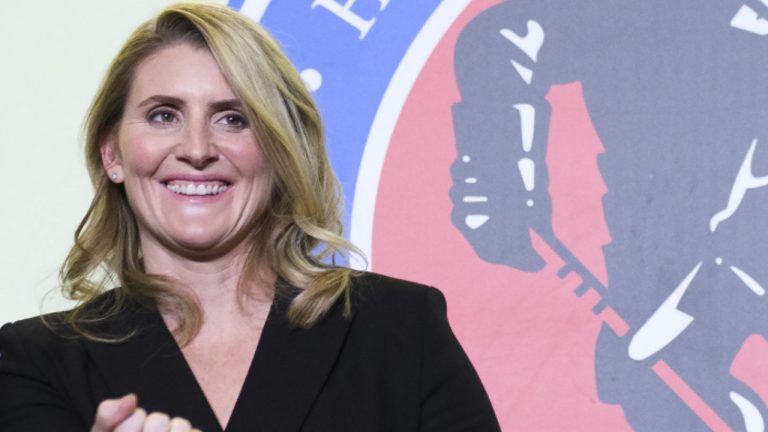 Hockey Hall of Fame inductee Hayley Wickenheiser shows off her ring on stage in Toronto on Friday, November 15, 2019. (Nathan Denette/CP)