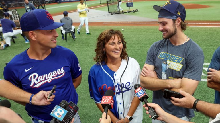 Texas Rangers' Nathaniel Lowe, left, and Tampa Bay Rays' Josh Lowe, right, talk to the media along with their mom, Wendy Lowe prior to a baseball game Friday, June 9, 2023, in St. Petersburg, Fla. (Mike Carlson/AP) 