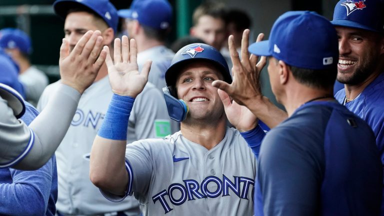 Toronto Blue Jays' Daulton Varsho celebrates with teammates after scoring against the Cincinnati Reds during the fourth inning of a baseball game Saturday, Aug. 19, 2023, in Cincinnati. (Joshua A. Bickel/AP)
