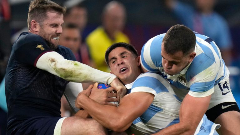 Argentina's Lucio Cinti, centre is tackled by England's Elliot Daly during the Rugby World Cup Pool D match between England and Argentina in the Stade de Marseille, Marseille, France Saturday, Sept. 9, 2023. (Pavel Golovkin/AP)