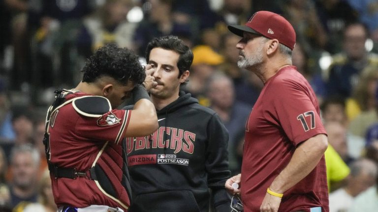 Arizona Diamondbacks catcher Gabriel Moreno talks to manager Torey Lovullo after being hit with a bat during the second inning of a Game 2 of their National League wildcard baseball series against the Milwaukee Brewers Wednesday, Oct. 4, 2023, in Milwaukee. (Morry Gash/AP)