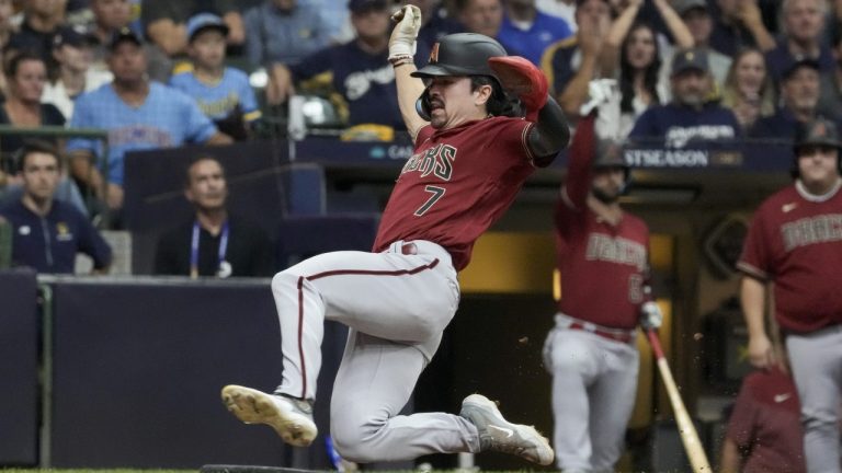 Arizona Diamondbacks' Corbin Carroll scores on a hit by Ketel Marte during the sixth inning of a Game 2 of their National League wildcard baseball series against the Milwaukee Brewers Wednesday, Oct. 4, 2023, in Milwaukee. (Morry Gash/AP)