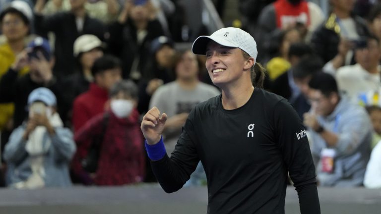 Iga Swiatek of Poland celebrates after defeating Liudmila Samsanova of Russia in the women's singles final match of the China Open tennis tournament at the Diamond Court in Beijing, Sunday, Oct. 8, 2023. (Andy Wong/AP)