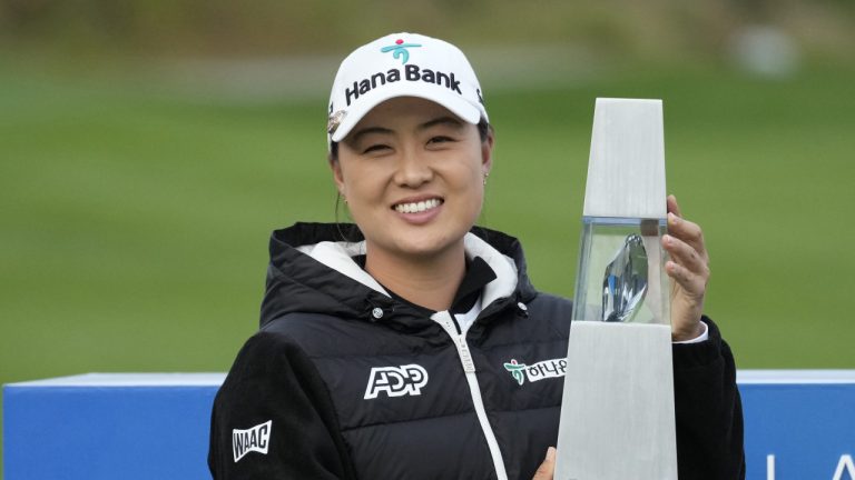 Minjee Lee of Australia celebrates with the winner's trophy after winning the BMW Ladies Championship at the Seowon Hills Country Club in Paju, South Korea, Sunday, Oct. 22, 2023. (Lee Jin-man/AP)