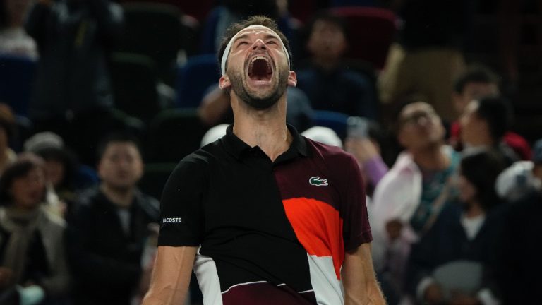 Grigor Dimitrov of Bulgaria celebrates after defeating Carlos Alcaraz of Spain in the 4th round of the men's singles match in the Shanghai Masters tennis tournament at Qizhong Forest Sports City Tennis Center in Shanghai, China, Wednesday, Oct. 11, 2023. (Andy Wong/AP)