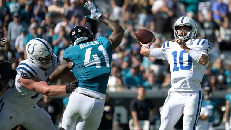 Indianapolis Colts quarterback Gardner Minshew looks to pass under pressure from Jacksonville Jaguars linebacker Josh Allen during the second half of an NFL football game, Sunday, Oct. 15, 2023, in Jacksonville, Fla. (Phelan M. Ebenhack/AP Photo)