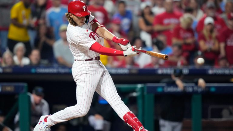 Philadelphia Phillies' Alec Bohm hits a run-scoring double against Miami Marlins pitcher Jesus Luzardo during the third inning of Game 1 in an NL wild-card baseball playoff series, Tuesday, Oct. 3, 2023, in Philadelphia. (Matt Slocum/AP)