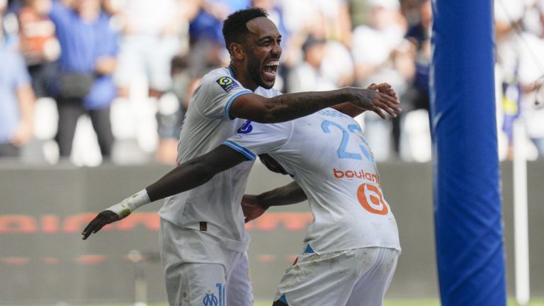 Marseille's Pierre-Emerick Aubameyang, left, and Marseille's Ismaila Sarr celebrate their side's thrid goal during the French League One soccer match between Marseille and Le Havre at the Velodrome stadium in Marseille, France, Sunday, Oct. 8, 2023. (Daniel Cole/AP)