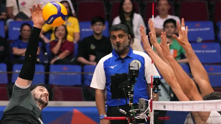 Canada's men's volleyball team has punched its ticket to the 2024 Paris Olympics.Canada's Stephen Timothy Maar, left, hits the ball during their game against Italy at the Men's Volleyball Nations League leg in Manila, Philippines on Thursday July 6, 2023. (Aaron Favila/AP)