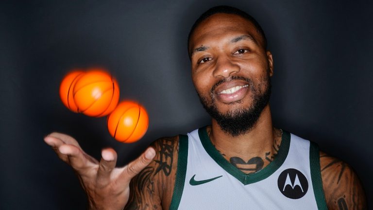 Milwaukee Bucks' Damian Lillard tosses some balls as he poses for a picture during the NBA basketball team's media day in Milwaukee Monday, Oct. 2, 2023. (Morry Gash/AP)