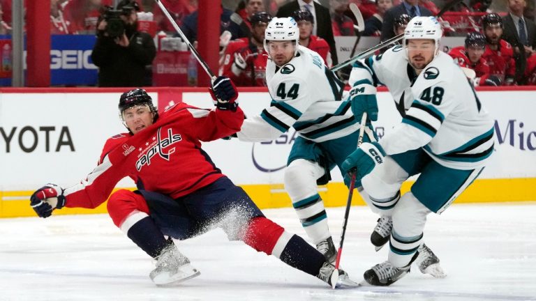 Washington Capitals right wing T.J. Oshie (77), San Jose Sharks defenseman Marc-Edouard Vlasic (44) and Sharks center Tomas Hertl (48) battle for control of the puck in the first period of an NHL hockey game, Sunday, Oct. 29, 2023, in Washington. (Mark Schiefelbein/AP Photo)