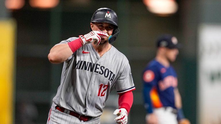 Minnesota Twins' Kyle Farmer celebrates his two-run home run against the Houston Astros during the second inning in Game 2 of an American League Division Series baseball game in Houston, Sunday, Oct. 8, 2023. (Tony Gutierrez/AP Photo)