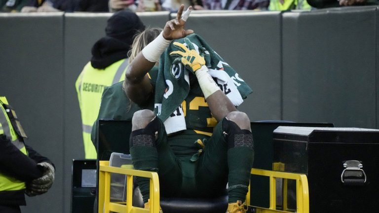 Green Bay Packers running back Aaron Jones is carted off the field during the first half of an NFL football game against the Los Angeles Chargers, Sunday, Nov. 19, 2023, in Green Bay, Wis. (Morry Gash/AP)