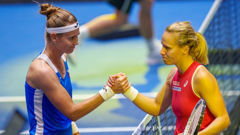 Czech Republic's Marie Bouzkova, left, shakes hands after defeating Switzerland's Viktorija Golubic after their group stage tennis match on the first day of the Billie Jean King Cup finals. (Manu Fernandez/AP)