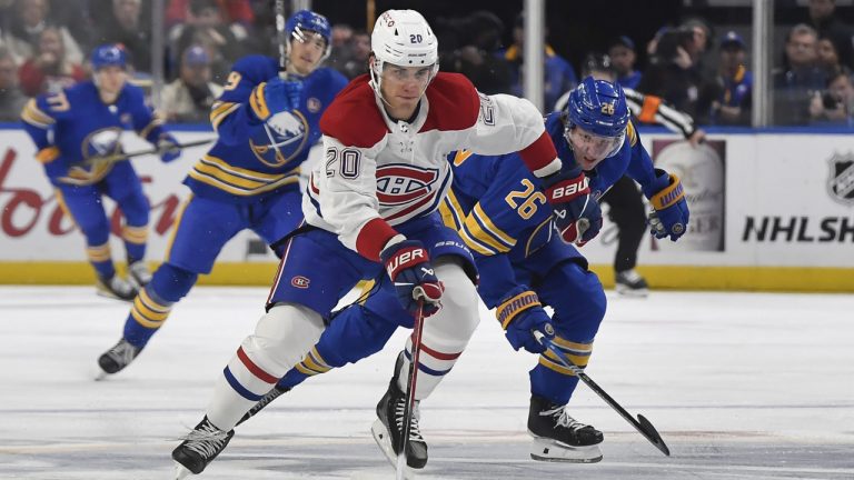 Montreal Canadiens left wing Juraj Slafkovsky (20) skates the puck way from Buffalo Sabres defensemen Rasmus Dahlin during the first period of an NHL hockey game in Buffalo, N.Y., Monday, Oct. 23, 2023. (Adrian Kraus/AP)