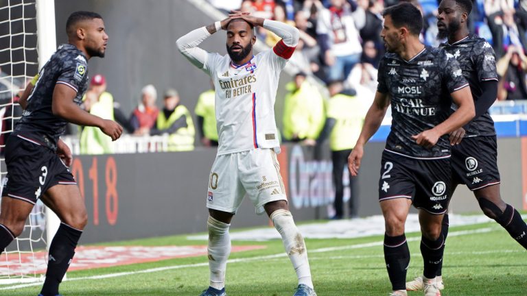 Lyon's Alexandre Lacazette, center, reacts after missing a goal during the French League One soccer match between Lyon and Metz in Decines, near Lyon, central France, Sunday, Nov. 5, 2023. (Laurent Cipriani/AP) 