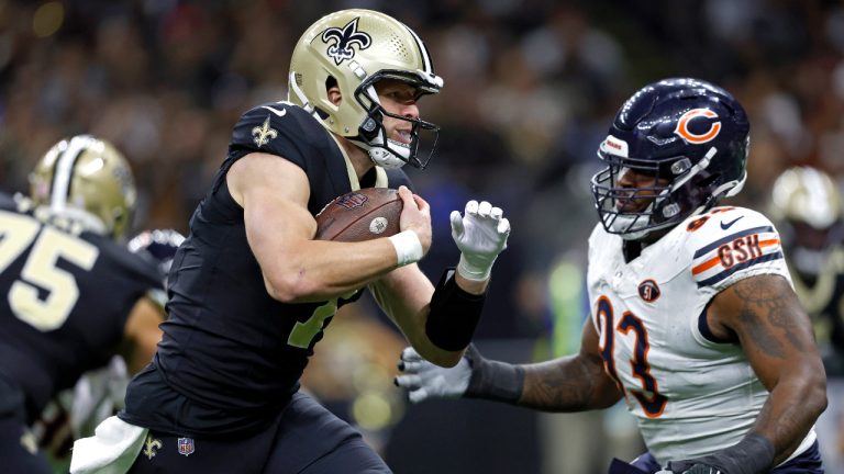 New Orleans Saints quarterback Taysom Hill (7) runs the ball past Chicago Bears defensive tackle Justin Jones (93) during an NFL football game, Sunday, Nov. 5, 2023, in New Orleans. (Tyler Kaufman/AP)