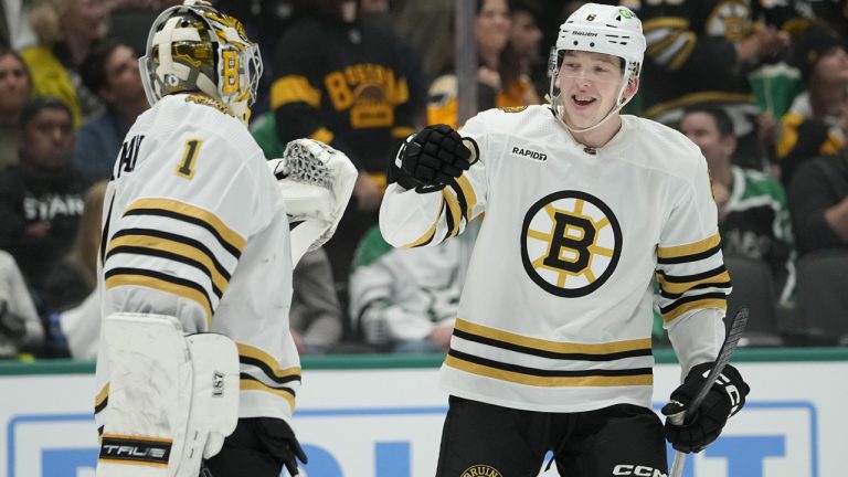 Boston Bruins defenceman Mason Lohrei, right, celebrates his first period goal with goaltender Jeremy Swayman during an NHL hockey game against the Dallas Stars, Monday, Nov. 6, 2023, in Dallas. (Julio Cortez/AP)