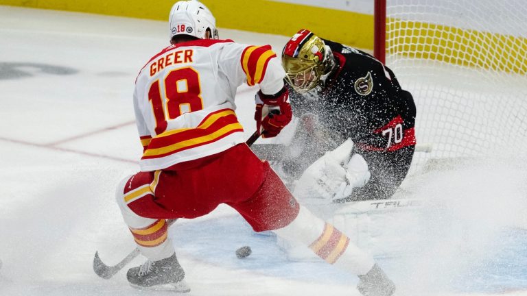 Calgary Flames left wing A.J. Greer sprays Ottawa Senators goaltender Joonas Korpisalo as he makes a save during first period NHL action, Saturday, November 11, 2023 in Ottawa. (CP)