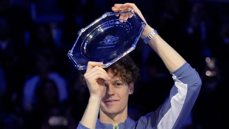Italy's Jannik Sinner holds the second placed trophy at the end of the singles final tennis match of the ATP World Tour Finals at the Pala Alpitour, in Turin, Italy, Sunday, Nov. 19, 2023. (AP Photo/Antonio Calanni)