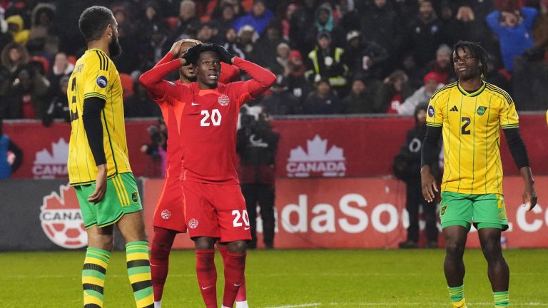 Canada's Jonathan David (20) reacts as Jamaica's Michael Hector (left) and Dexter Lembikisa (2) look on during second half CONCACAF Nations League quarterfinal soccer action in Toronto on Tuesday, November 21, 2023. (Chris Young/CP)