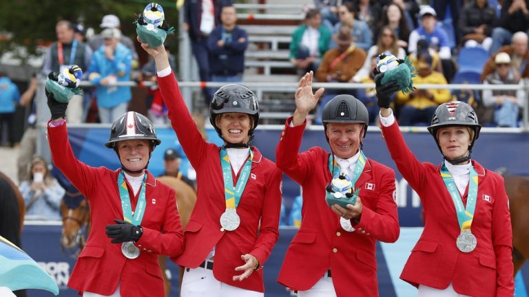 Canada celebrates their silver medal in equestrian jumping at the Santiago 2023 Pan American Games in Quillota, Chile, Wednesday, Nov. 1, 2023. From left to right: Beth Underhill, Amy Millar, Mario Deslauriers, and Tiffany Foster. (CP/HO-Santiago 2023, Photosport, Miguel Campos)