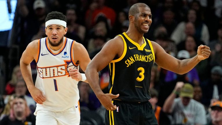 Golden State Warriors guard Chris Paul looks for a call as Phoenix Suns guard Devin Booker runs up court after a basket during the first half of an NBA basketball game, Wednesday, Nov. 22, 2023, in Phoenix. (Matt York/AP Photo)