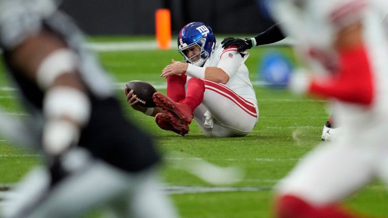 New York Giants quarterback Daniel Jones grimaces after a sack during the first half of an NFL football game against the Las Vegas Raiders, Sunday, Nov. 5, 2023, in Las Vegas. (John Locher/AP Photo)