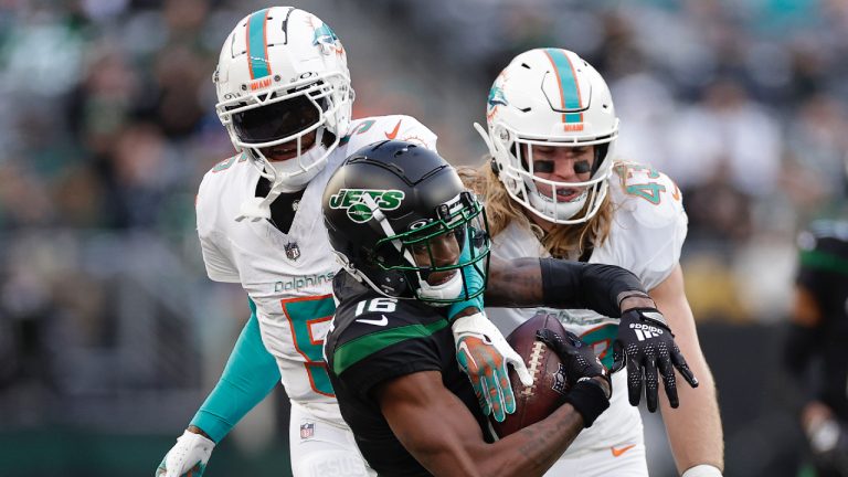 Miami Dolphins cornerback Jalen Ramsey (5) pulls down New York Jets wide receiver Jason Brownlee (16) during the first quarter of an NFL football game, Friday, Nov. 24, 2023, in East Rutherford, N.J. (Adam Hunger/AP)